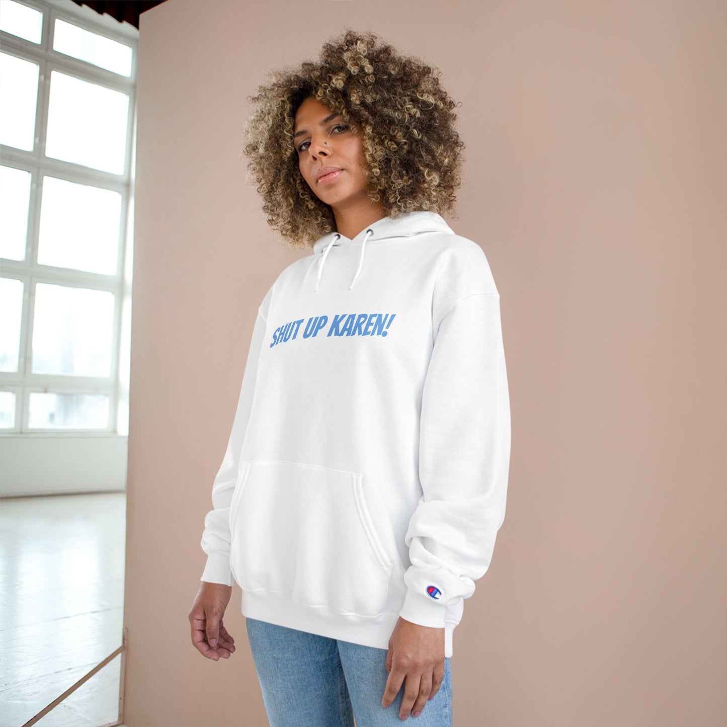 A woman wearing a white Unisex ‘Nobody Cares, Karen’ hoodie — satirical design mocking self-appointed morality police and modern conformity