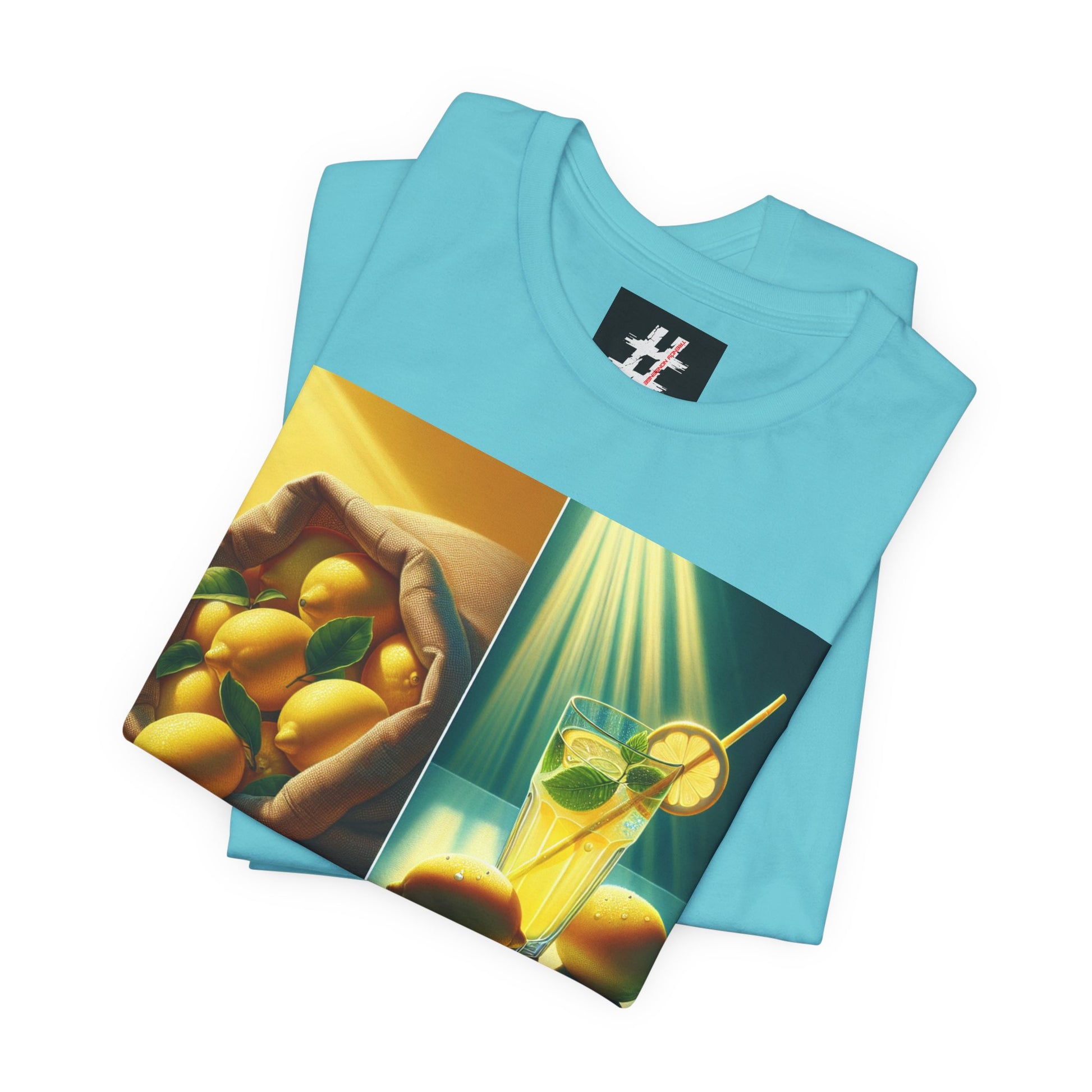 Folded blue t-shirt with lemon-themed graphic design on a white background