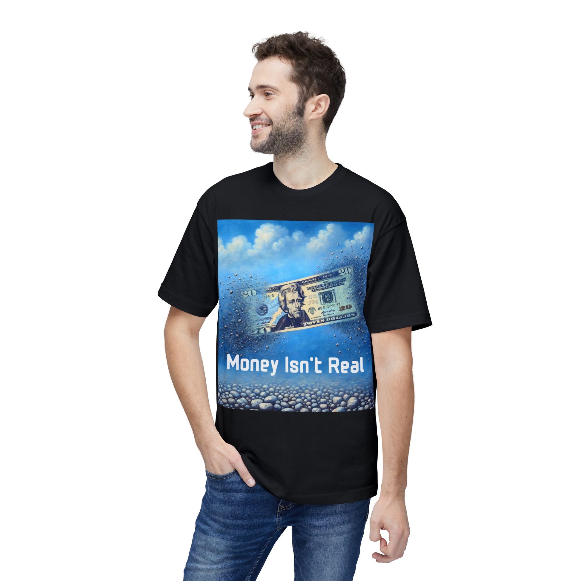 Man wearing a black Unisex ‘Money Isn’t Real’ graphic tee — $20 bill dissolving into pebbles, symbolic design questioning the illusion of money and the real value of time.