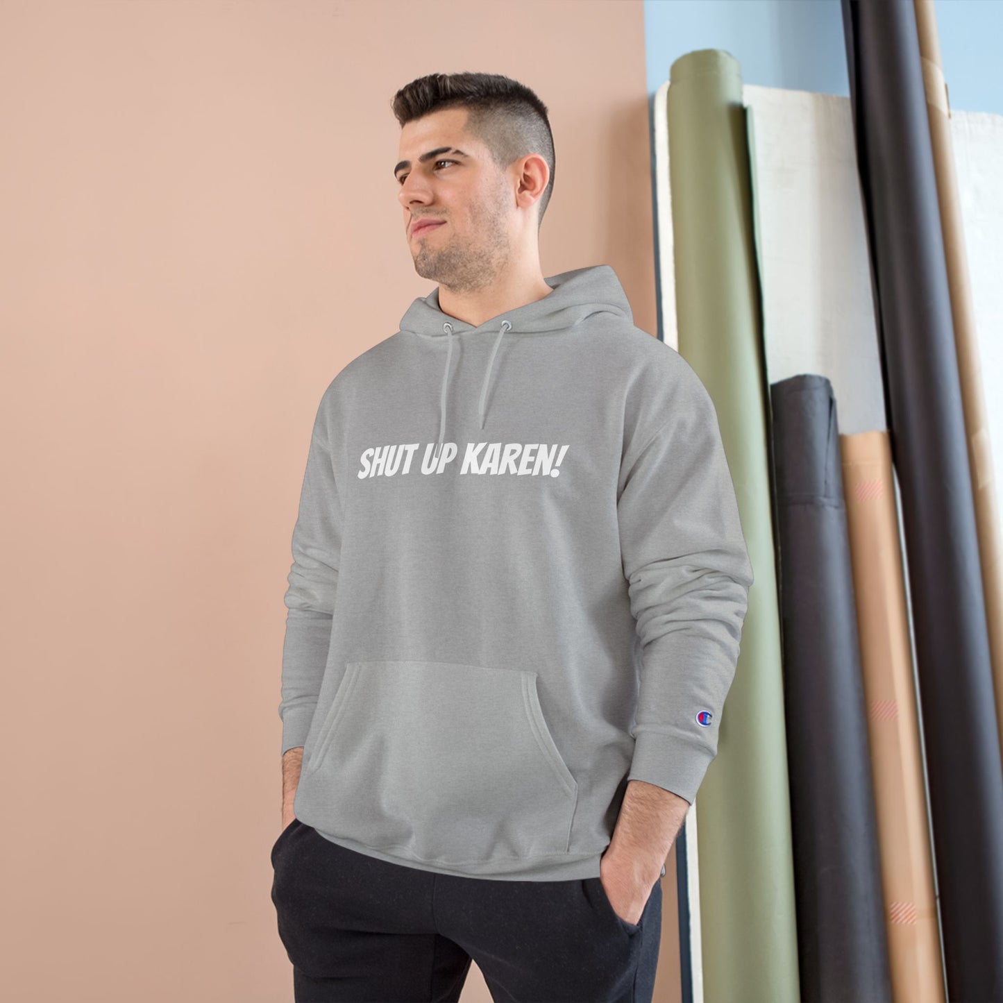 A man wearing a gray Unisex ‘Nobody Cares, Karen’ hoodie — satirical design mocking self-appointed morality police and modern conformity
