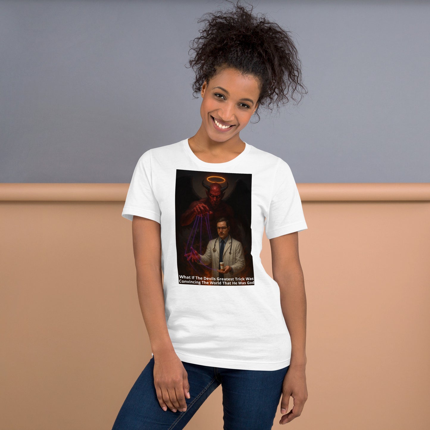A woman wearing a white Unisex The Lie We Worship graphic tee — provocative design of devil controlling doctor puppet, confronting blind faith and false narratives.